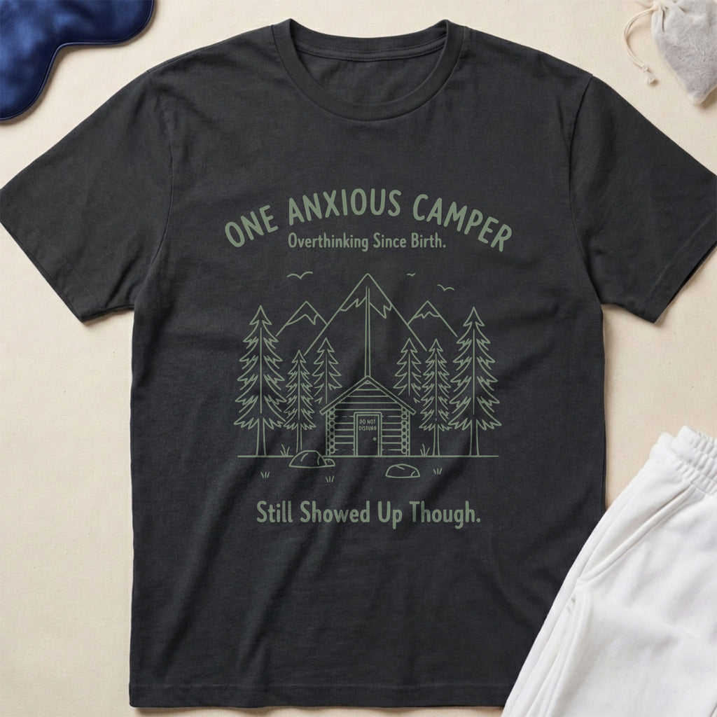 Black t-shirt with 'One Anxious Camper' graphic and text on a beige background